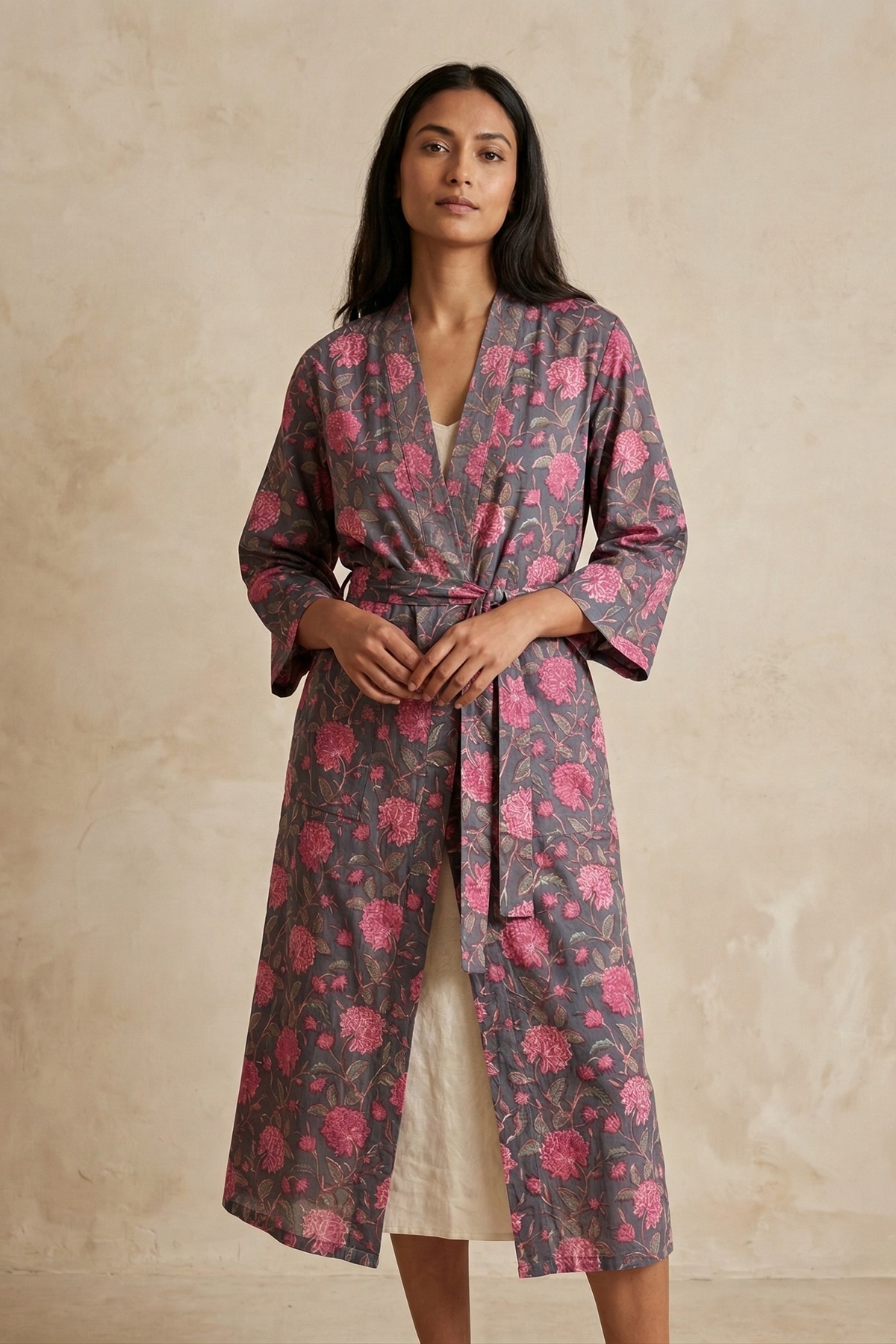 Woman in the Joyce long cotton kimono robe, charcoal gray with pink blooms, hand block printed