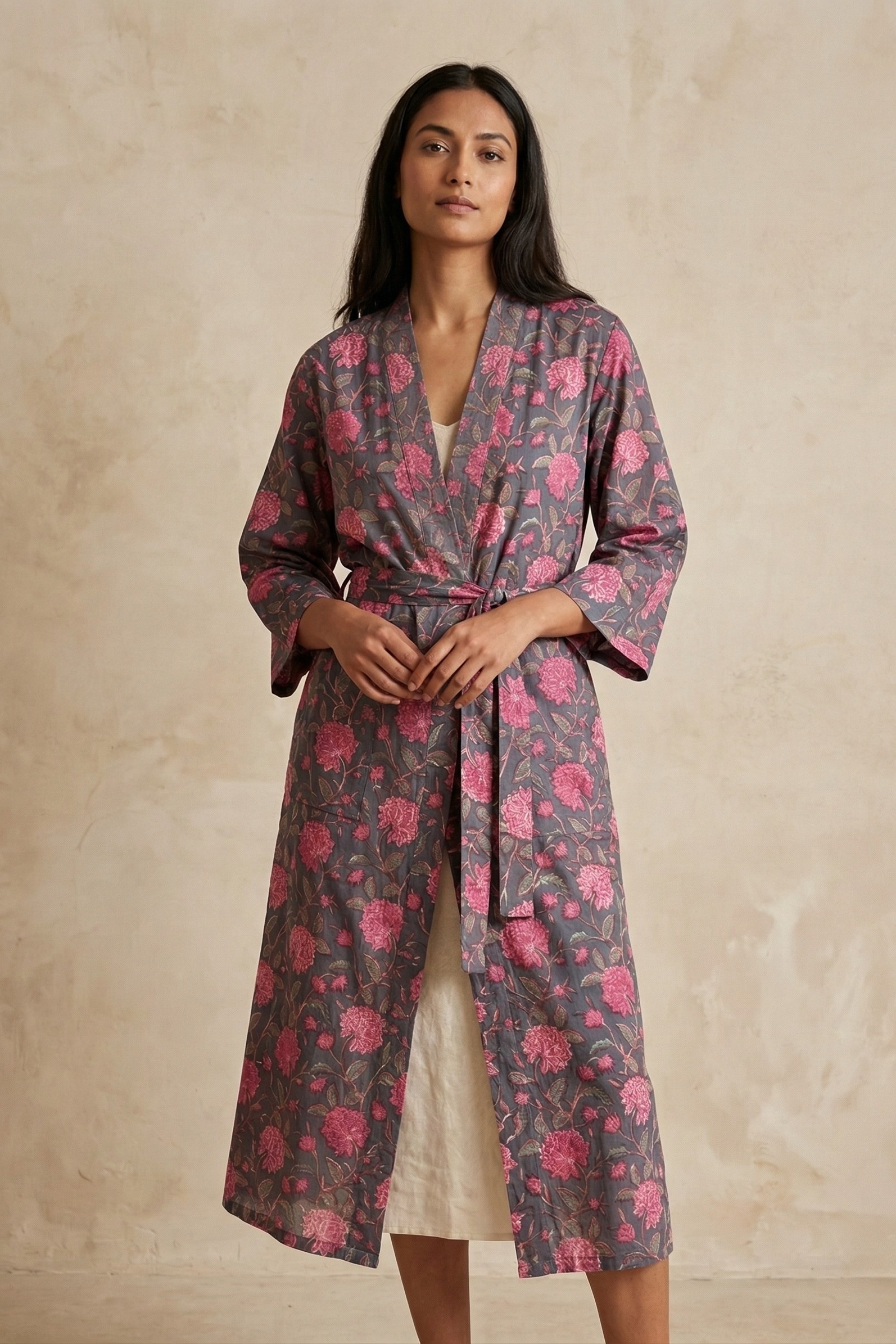 Woman wearing a floral robe against a beige background